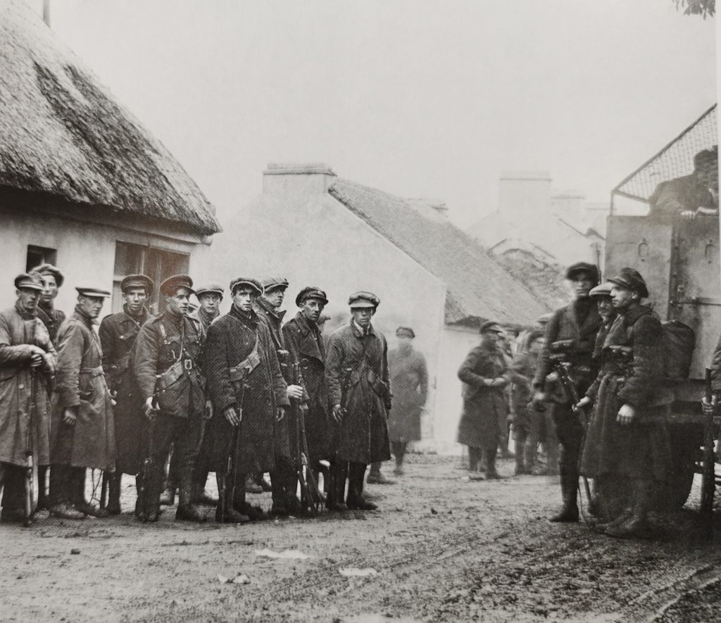 Black and white photo of Free State Troops gathered outside cottages at Claregalway